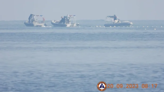 Philippines denounces China for erecting floating barrier in contentious South China Sea