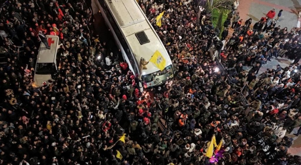 Aerial-View-Of-Large-Crowd-Surrounding-A-Bus-As-People-Wave-Flags_20250130_204944_0000