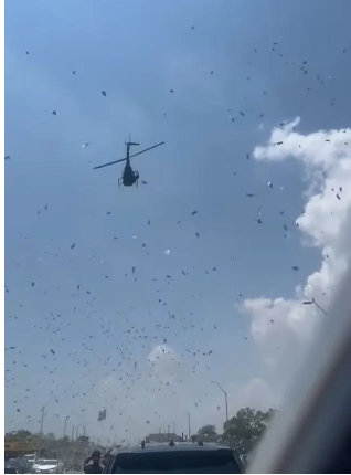 The moment a dead man’s life savings are dropped from a helicopter as strangers rush to grab handfuls of the money